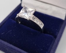 BOXED silver diamante ring 1.5 carat centre stone smaller stones on shoulder