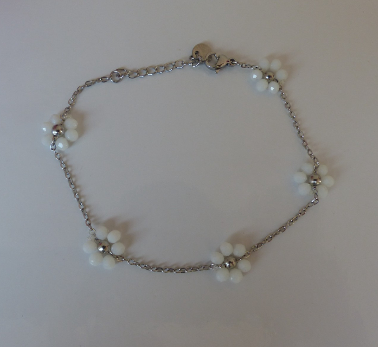 Bracelet fleurs blanches en acier argenté pour sublimer vos tenues d'été