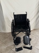 Standard black wheelchair with foot/leg supports