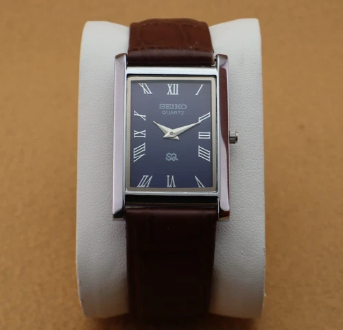 Vintage Seiko Slim Quartz Men's Wrist Watch Blue Dial with Dark Brown Strap.