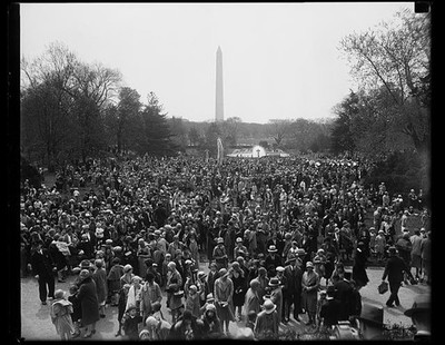Washington children roll Easter eggs on White House lawn. Scene on the south
