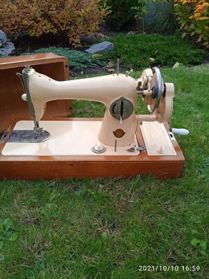 Vintage manual sewing machine in a wooden case from the 1960s