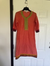 peach-colored kurti tunic featuring green neck embroidery traditional hem