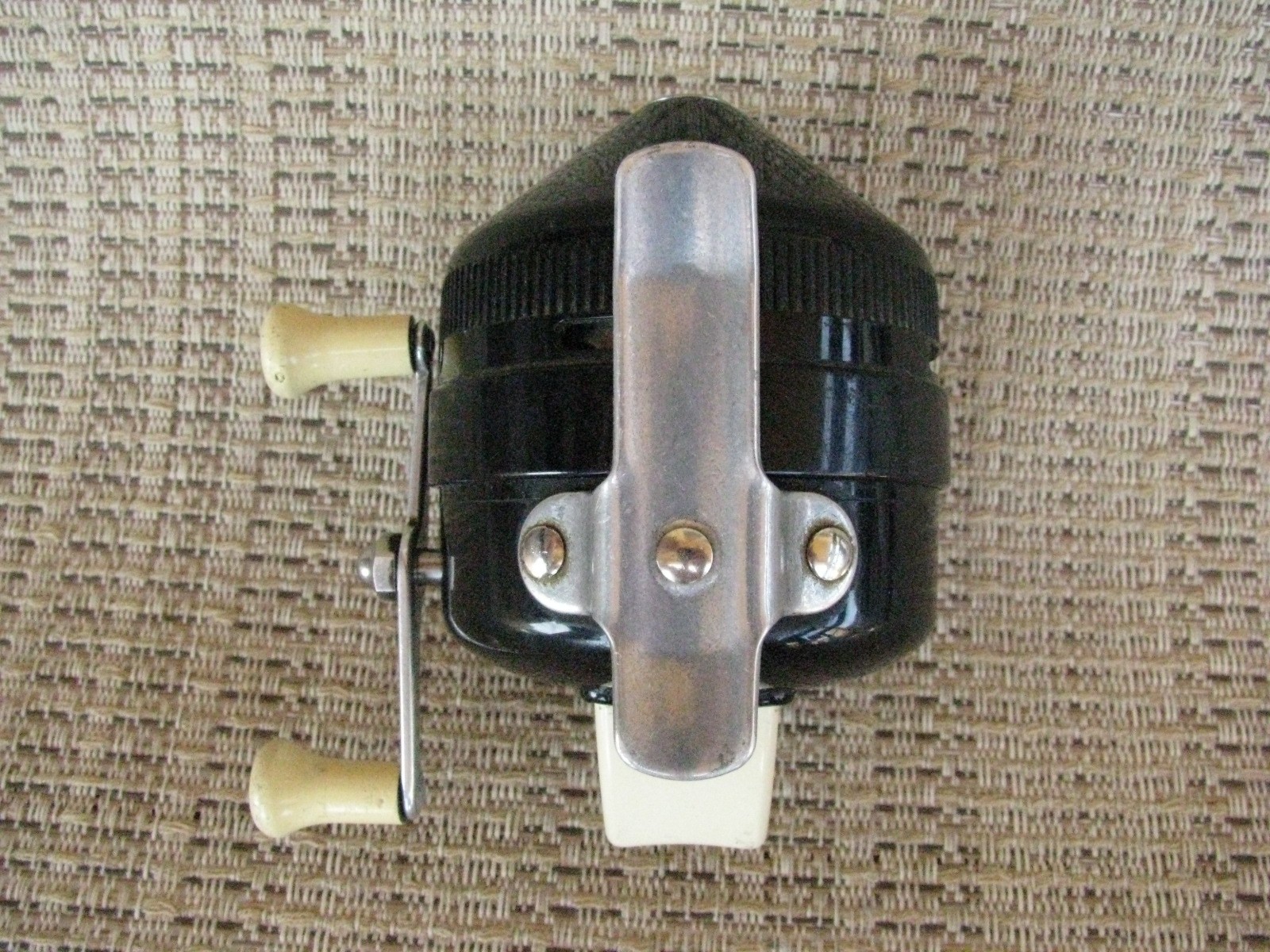 Black Zebco 202 spin casting reel with silver handle, cream end cap, and metal body, made in USA!