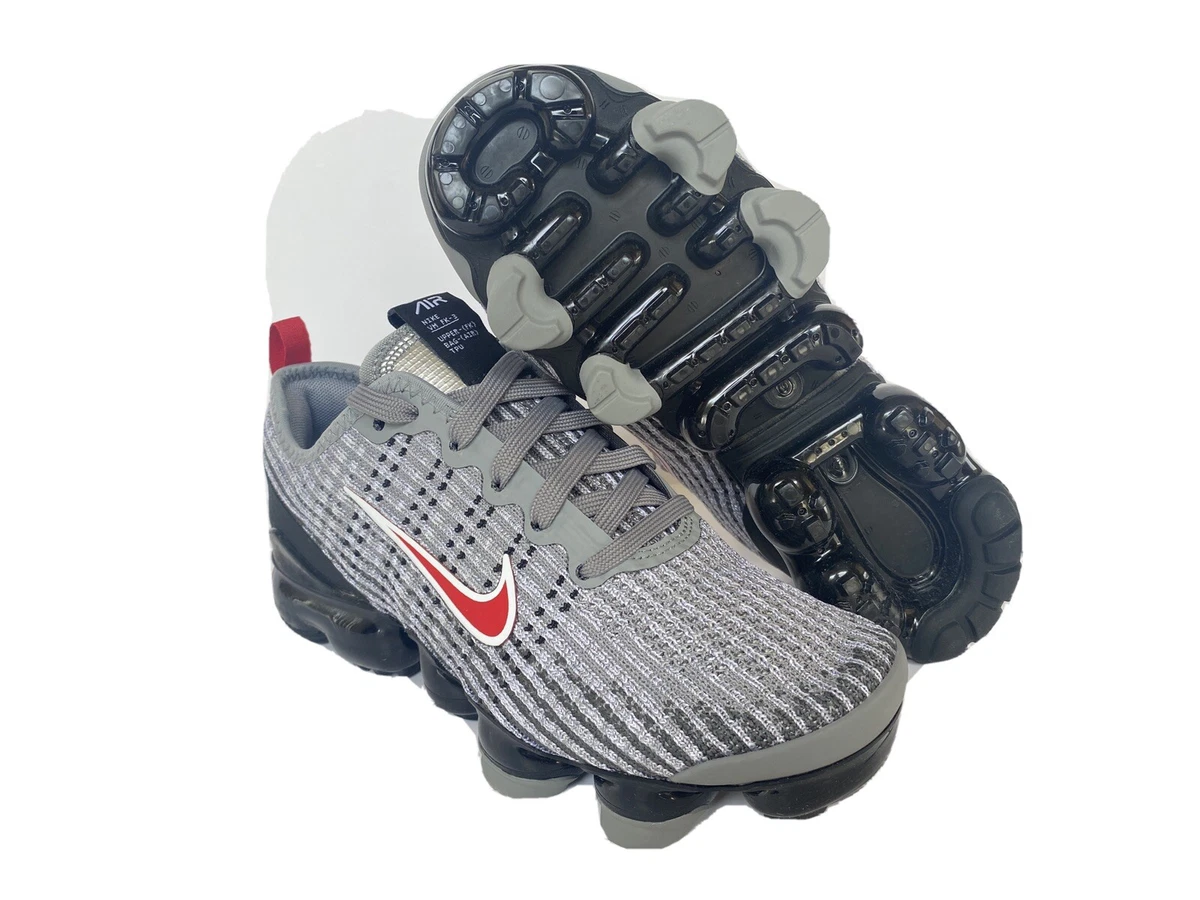 Grey and store red vapormax