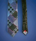Robert Graham men’s neck tie with multicolor patchwork design, black and white checkered pattern, and red made in USA label.