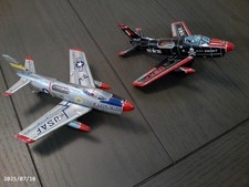 two tin friction powered jet fighter airplanes