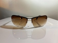 Unisex, half rim, minimalistic sunglasses with brown lenses gold wire frame.