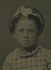 YOUNG GIRL, TOUGH STANCE. PRINT DRESS, HAT. TINTYPE.