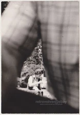 Through the Curve of Arm Distant Woman Caught in Abstract Framed Moment Photo