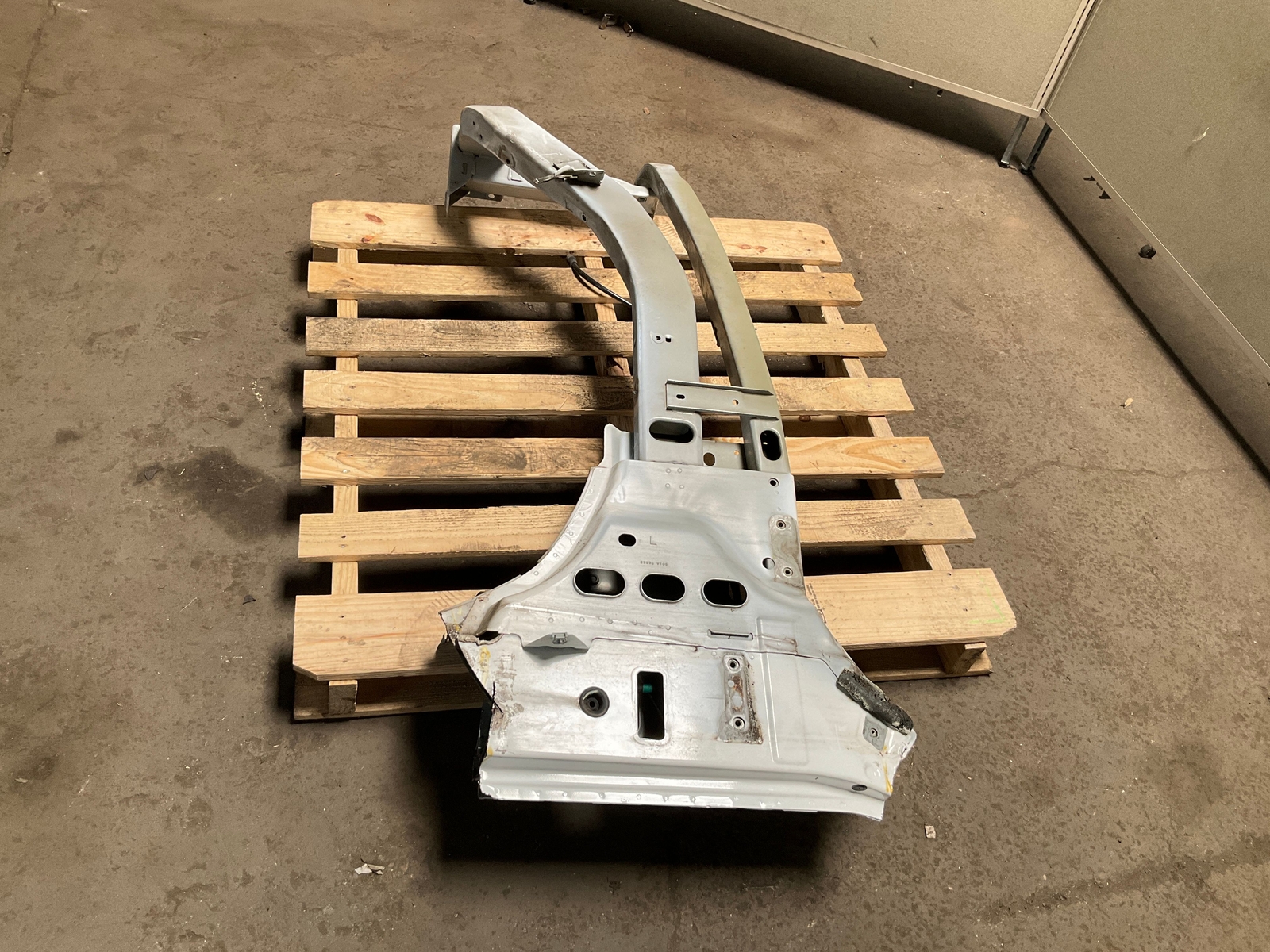 Silver 13-18 RAM 1500 front left driver frame apron radiator support with jagged edges on concrete pallet.