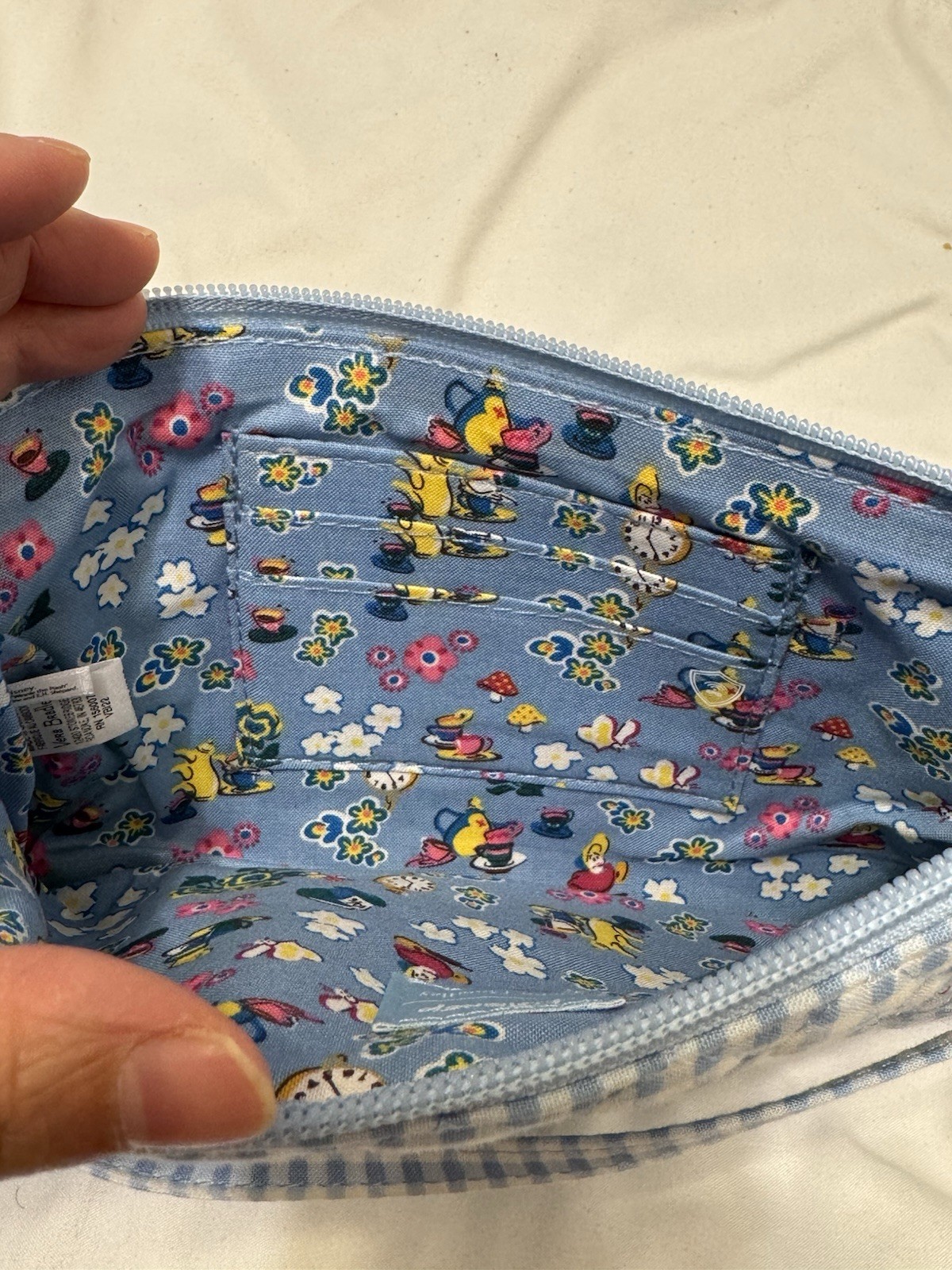 Vera Bradley’s Disney RFID Convertible Wristlet, featuring “Alice in Wonderland”