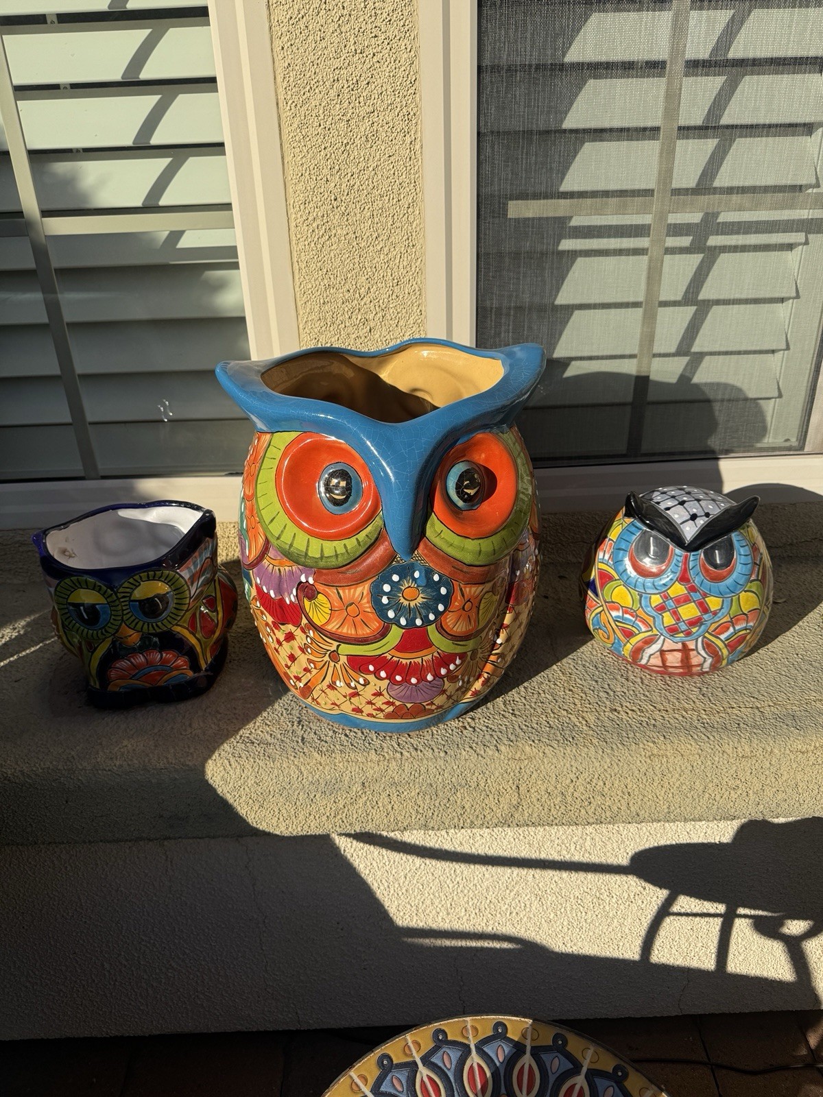 Three hand-painted ceramic owl planters in the style of Mexican Talavera