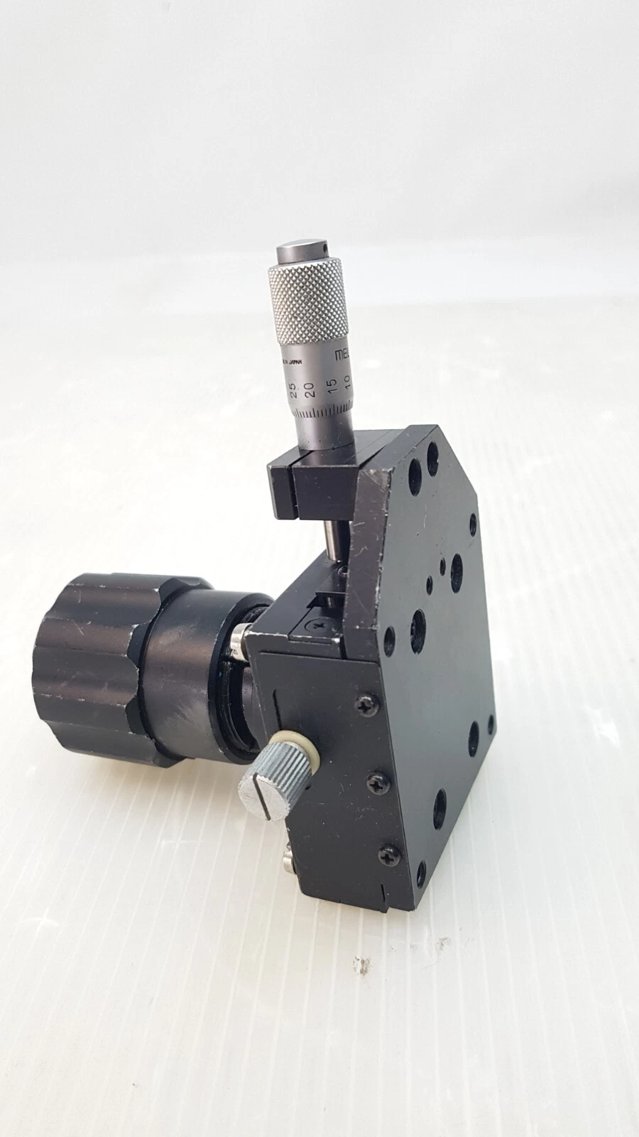 Melles Griot stage standing on end, micrometer on top and mount at the side