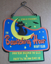 Halloween Sign Features a Black Cat Sitting on a Yellow Crescent Moon