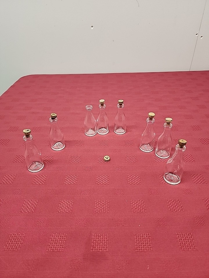 Pre-1960s UGB mini apothecary bottles with original corks — genuinely pre-metric era glass with age verification, a true collector's set of eight miniatures.