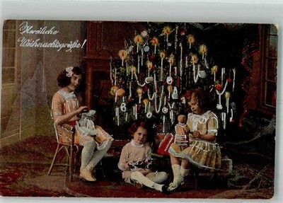38163213 - Children with toys and dolls in front of the decorated Christmas tree
