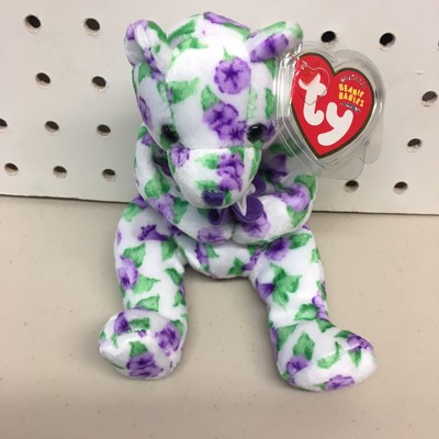 purple beanie baby with white flower