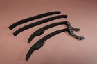 Black 1998-2015 Yamaha VStar V Star 650 XVS650 cam shaft timing chain guides with bent-over design on a brown surface.