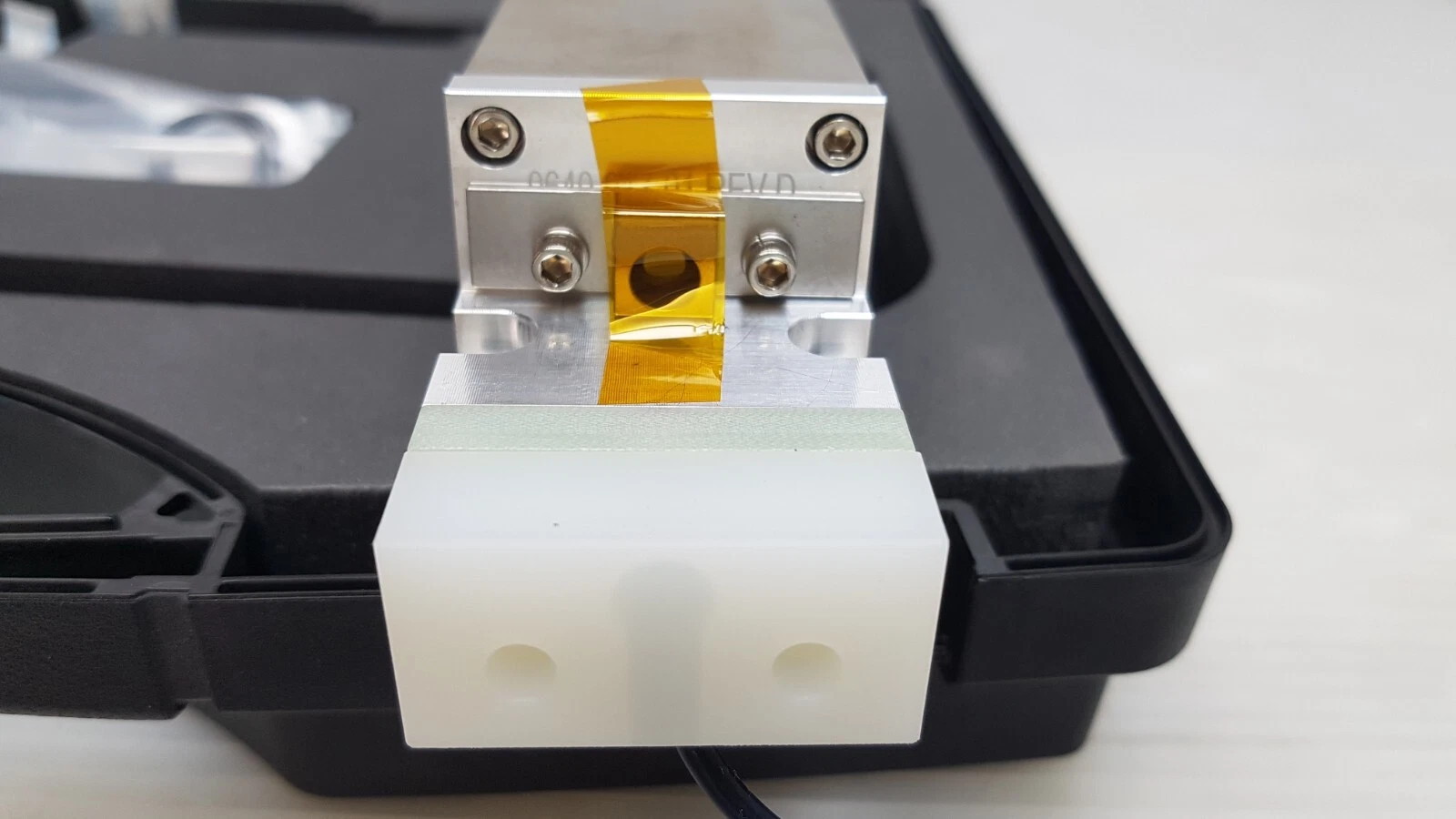 End block of the 0638-614-01 assembly with amber tape over the opening