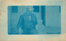 Granpop and Little Boy Grandson Sitting on Front Porch Stoop RPPC Postcard