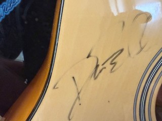 Guitar signed by the Eagles in a display case.