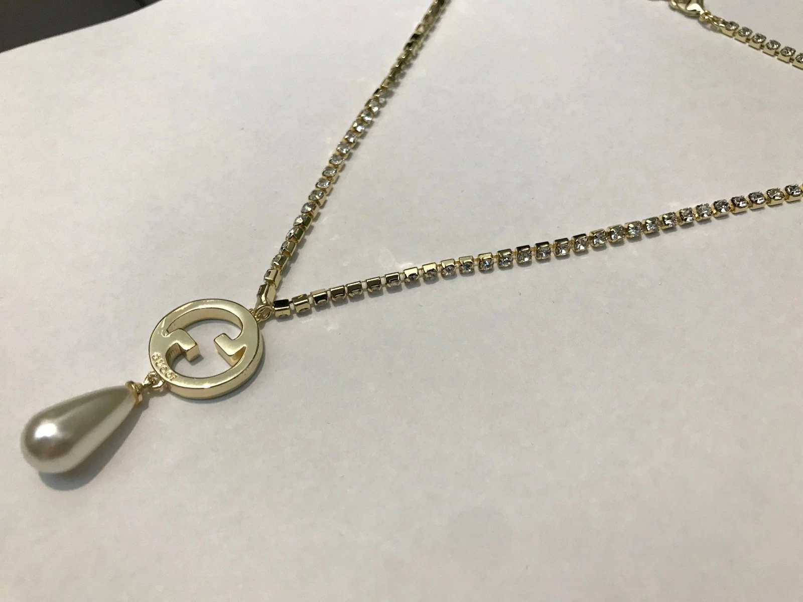 Collana Gucci GG con ciondolo ad incastro tono oro