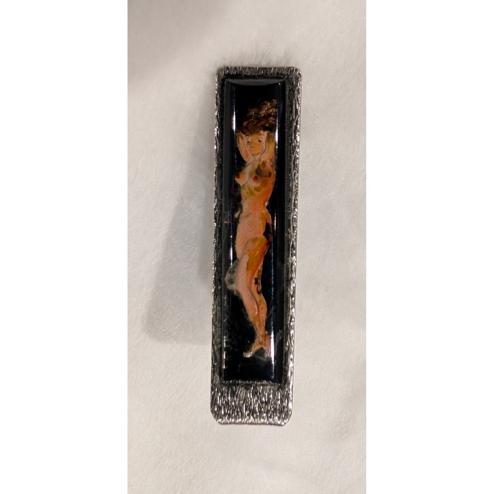 A mid-century nude lady enamel tie clip — the kind of risqué, artful detail a Mad Men character would have in his dresser drawer, dripping with retro personality.
