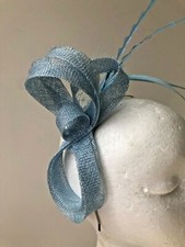 New light blue loop fascinator with netting and feathers on a silver metal headb