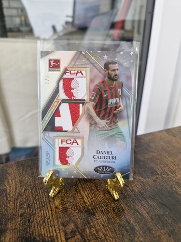 2021-22 Topps Tier One Bundesliga Daniel Caligiuri Magic Triple Relic True 1/1