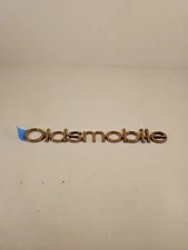 New Oldsmobile Cutlass Supreme NOS GM Rear Nameplate Emblem 16502255