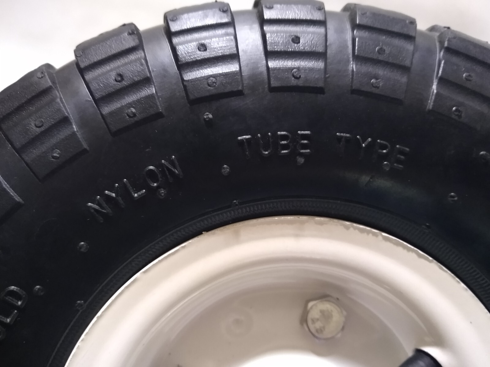 10 Inch HaulMaster Pneumatic Knobby Tire White Wheel 4.10/3.504 (5/8