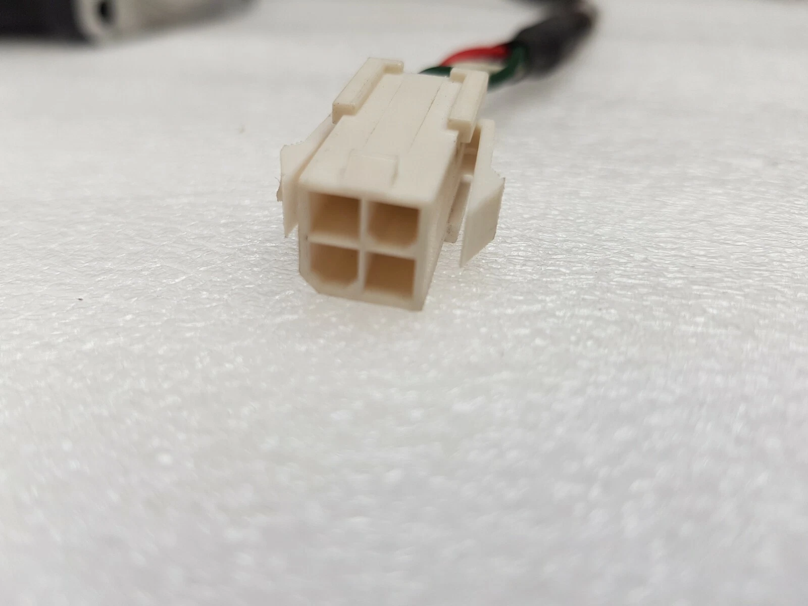 White 4-way power plug on the Emerson servo motor cable