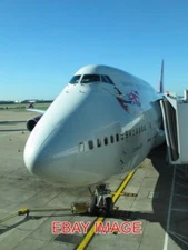 PHOTO  COSMIC GIRL MY VIRGIN ATLANTIC 747 WAITING AT TERMINAL THREE . 2010