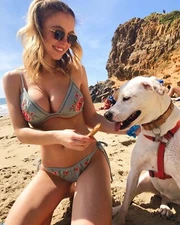 Sydney Sweeney Posing On The Beach Feeding Her Dog 8x10 Picture Celebrity Print