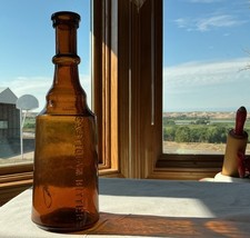 Castilian Bitters Bottle Yellow With Copper Tones.