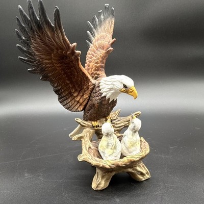Vintage ceramic bald eagle figurine with chicks in a nest.