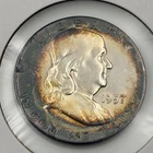 1957 P Franklin Half Dollar with peripheral toning and light rainbow qualities