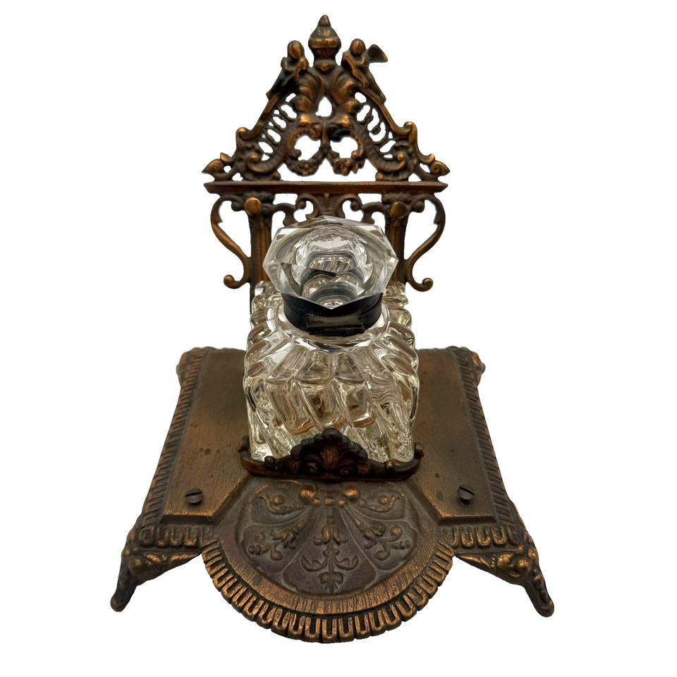 An ornate Victorian brass inkwell that looks like it could have sealed a letter to the Queen — the pinnacle of antique desk drama.