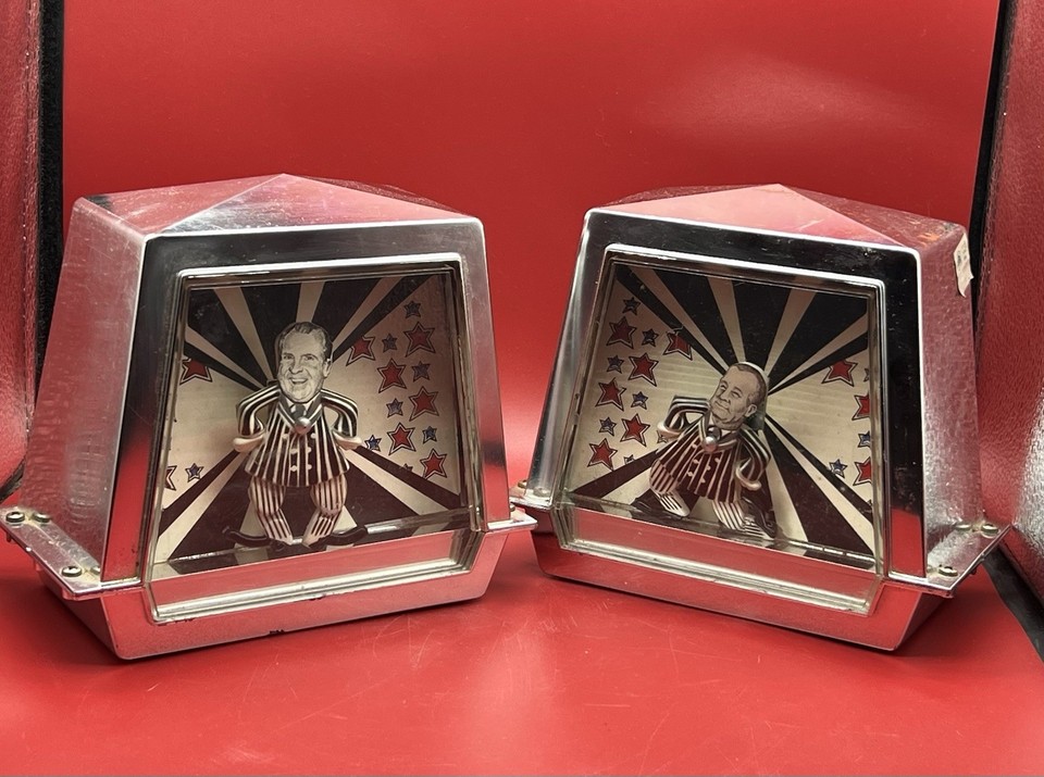 A RARE pair of animated wind-up music boxes depicting Nixon and Agnew — political satire frozen in time, these are genuine pieces of 1970s pop-culture history.