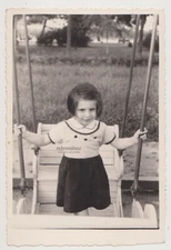 Cute Young Girl on a Swing Capturing the Joy of an Upward Glide Snapshot Photo