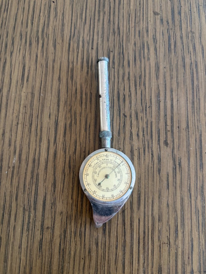 A German-made opisometer — a tiny brass wheel that rolls along map curves to measure distances — obscure, precise, and wildly satisfying to use.