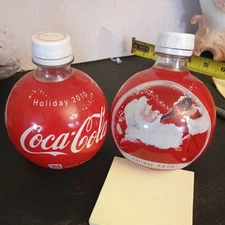 2 Coca Cola 2010 Holiday Plastic Christmas Bottles opened