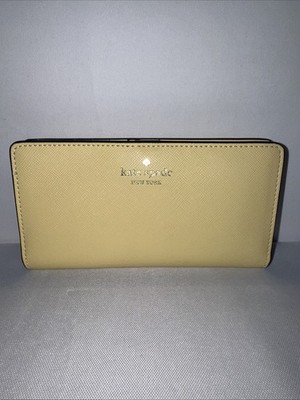 Kate Spade Staci large slim bifold wallet in the color Lemon Fond. NWOT..