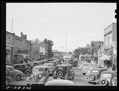Photo:Main Street Small Town USA 1930s Cars Traffic Downtown Street Scene