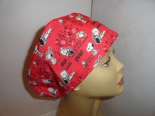 Ladies scrub hat with piano man and black and white happy dog. Elastic in back.