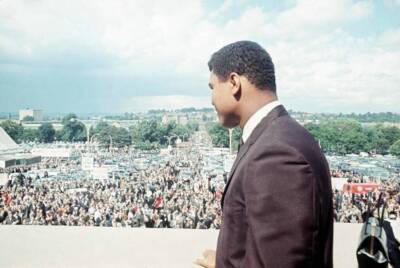 Cassius Clay watches the crowds arrive at Wembley Stadium for the - Old Photo