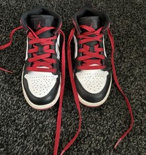 Used Air Jordan 1 Mid sneakers in black, white, and red. Uk 13.5