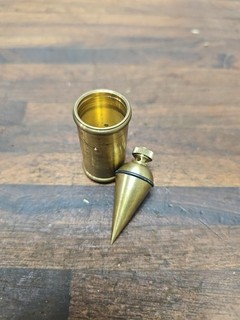 K849 interesting small brass 1.8 oz plumb bob with brass stand