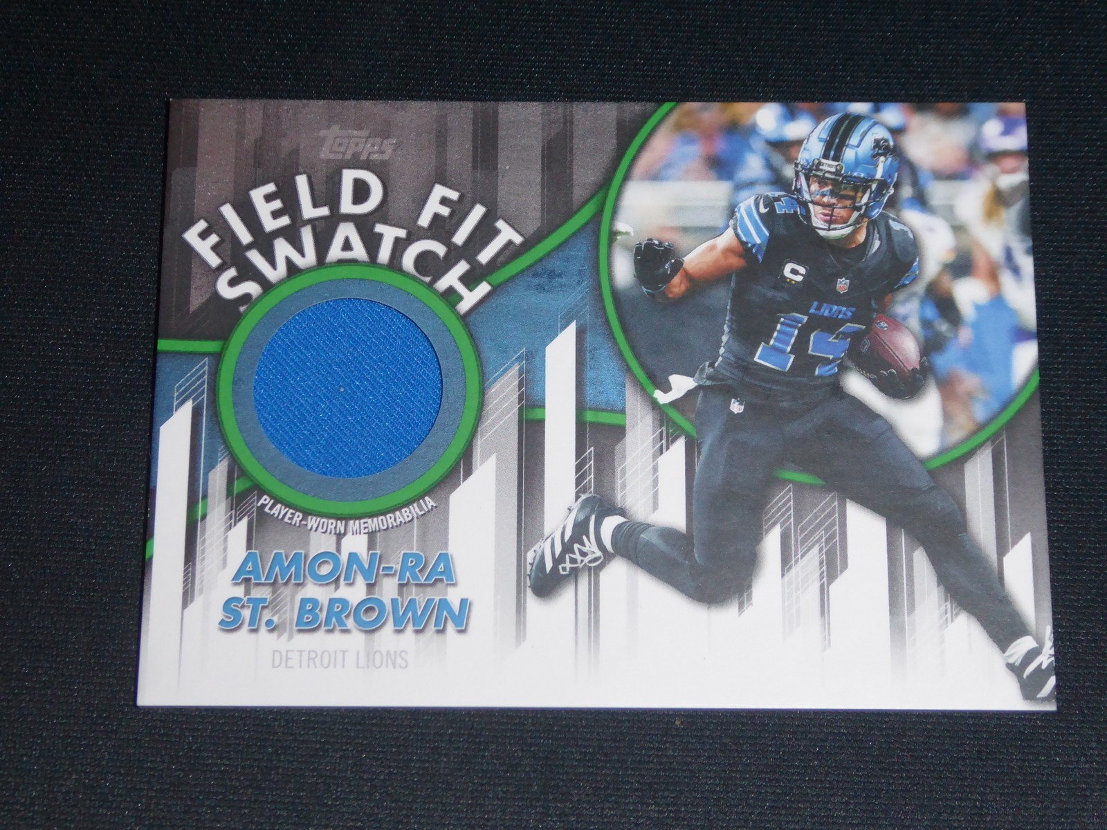 2026 Topps Flagship #FFSC-AS Amon-Ra St. Brown Field Fit Swatches Green #/99